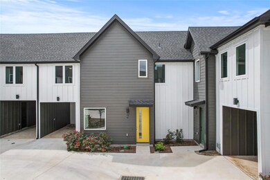 View of front of property featuring a shingled ro