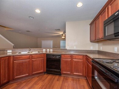Spacious kitchen with breakfast bar is open to the