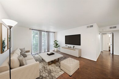 Another angle of the living room showing the floor to ceiling windows letting in plenty of natural light. Virtually staged.
