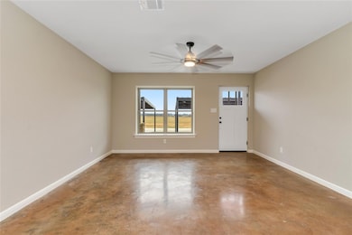 Foyer entrance with concrete floors and ceiling fa