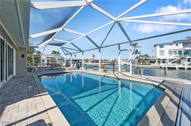 View of swimming pool featuring canal view, a dock