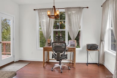 Office area with a notable chandelier and dark har