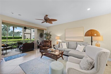 Living room with ceiling fan and light tile floori