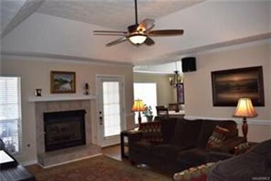 Tall ceilings and gas fireplace make this room app