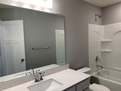 The hall bathroom features a quartz vanity top that allows everyone to get moving on those busy mornings. Model photo.