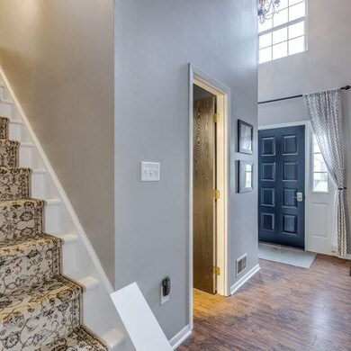 New runner leading up stairwell to second floor. 2-story entry, half bath with updates.