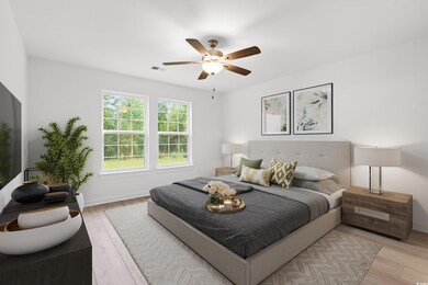 Bedroom featuring wood finished floors and a ceiling fan