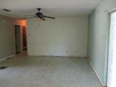 View of living room from kitchen, with a textured 