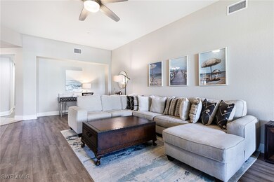 Living room featuring ceiling fan and hardwood / w