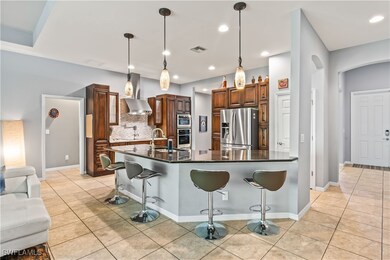 Kitchen featuring a kitchen breakfast bar, hanging