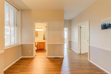 Past the entryway is a square foyer with access to