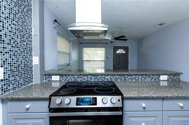 Gorgeous QUARTZ countertops with custom tiled backsplash. Stainless Steel appliances and range hood.