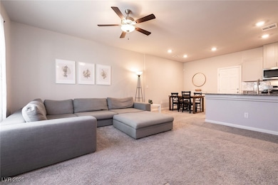 Living room featuring a ceiling fan, recessed ligh