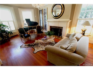 THE BAY WINDOW ADDS A GREAT ARCHITECTURAL DETAIL TO THE LIVING ROOM AND THE GAS FIREPLACE  WITH MARBLE SURROUND AND MULTIPLE MEMBER CROWN MOLDING ARE BONUSES.