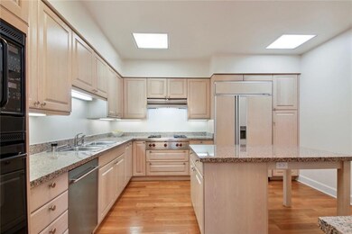 Kitchen features stone counters and stainless stee