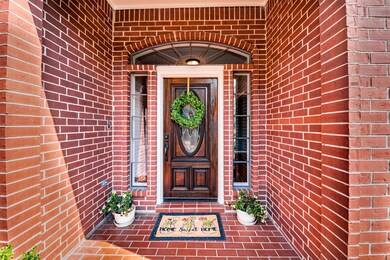 Lovely front door framed with windows greets guest