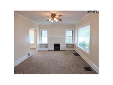 Large living room with new carpet and fireplace.