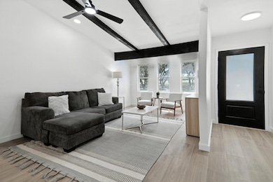 Living area featuring light wood-style floors, be