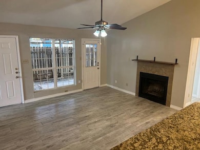Unfurnished living room featuring a tile fireplac