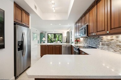 Kitchen featuring a peninsula, visible vents, appl
