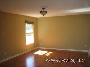 master bedroom with hardwoods