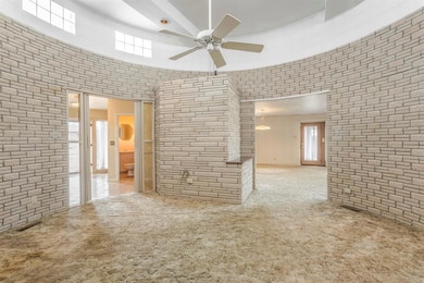 Spare room with plenty of natural light, carpet flooring, and a ceiling fan