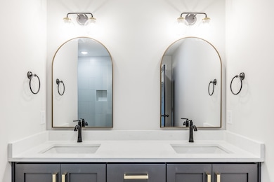 Primary bathroom has double vanity and large tiled shower~