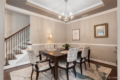 Dining space with a tray ceiling, hardwood / wood-