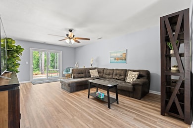 Living area featuring ceiling fan, light wood-styl