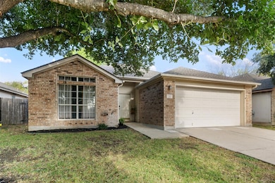 Ranch-style house featuring brick siding, an atta
