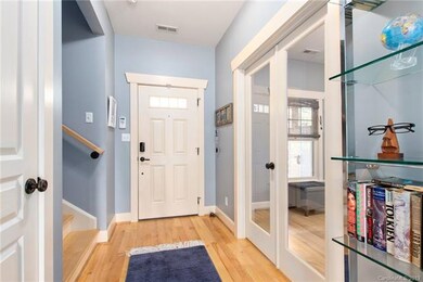 Entryway with large closet, glass doors on private office space.