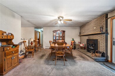 The dining room includes a fireplace with brick su