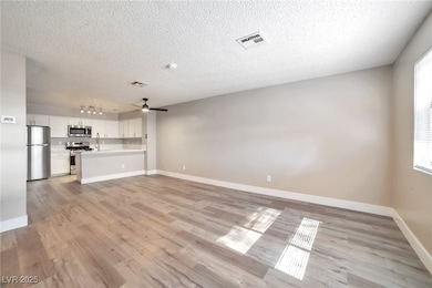 Unfurnished living room featuring baseboards, visi