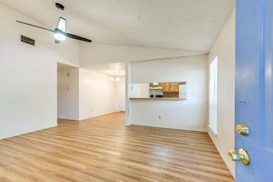 Unfurnished living room with vaulted ceiling, a t