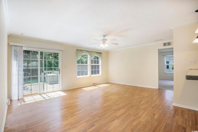 Empty room featuring plenty of natural light, light wood-style flooring, ornamental molding, and a ceiling fan