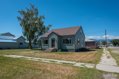Bungalow-style home with a front lawn and roof with shingles