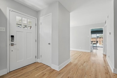 Entrance foyer with baseboards and light wood-type