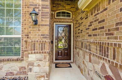 The exterior details an inviting and comfortable brick and stone elevation with amazing curb appeal.