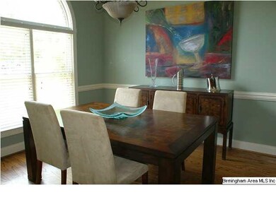 Formal dining room has chair rail, palladium windo