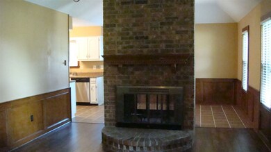 Den with hardwood flooring. Notice the two sided f