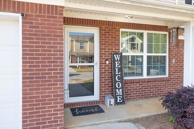 View of exterior entry with brick siding