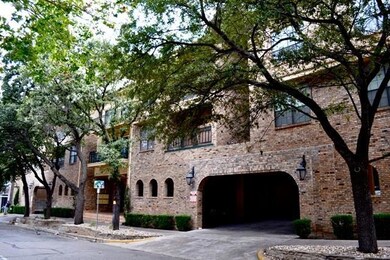 View of property featuring a garage and driveway