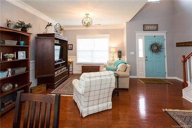 Living room or flex space with hardwoods and 2 sto
