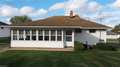 The View of back of home.  Window filled room is the 3 Season Room.