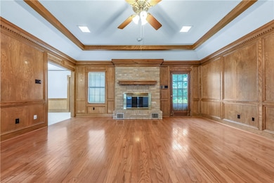 Unfurnished living room featuring a ceiling fan, a