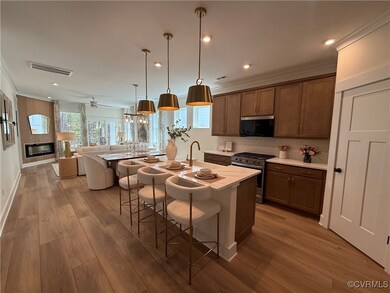 STAGING. The kitchen features a center island, qua