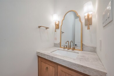 Elegant powder bath with White Oak floating cabine