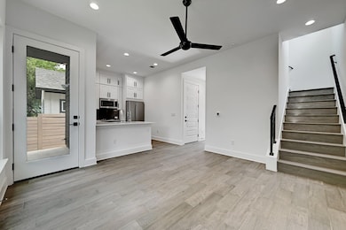 Unfurnished living room featuring stairs, recesse
