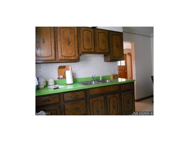 Updated kitchen has newer cabinets and a break nook.  Refrigerator and stove to stay with property.