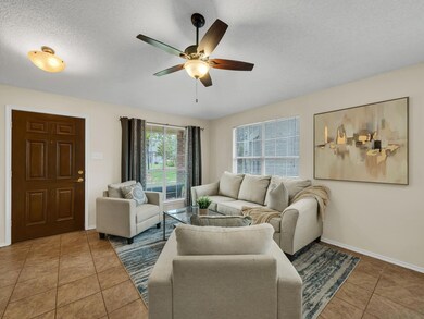 Tiled living room featuring a textured ceiling and